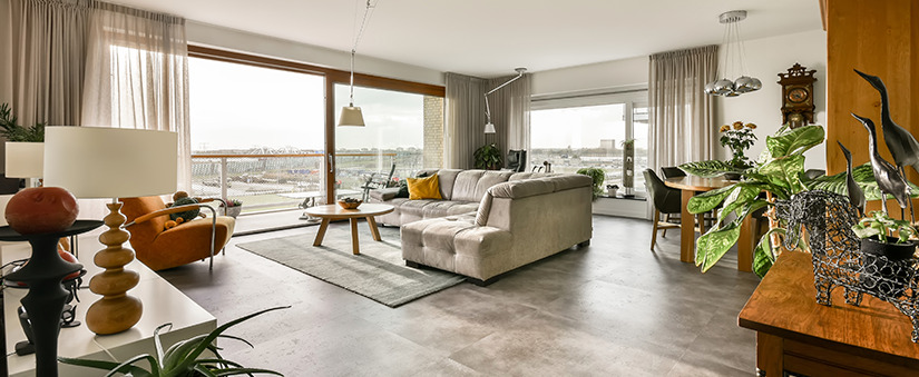 Marketing imobiliário: sala de estar ampla com paredes de vidro.