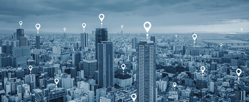 coleta de dados: imagem aérea de edifícios com ilustrações de pin de localização em cima.