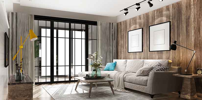 O que é pé direito: imagem de uma sala de estar moderna, com um sofá próximo à parede, uma mesa de centro e, à frente, uma televisão na parede e um rack abaixo.