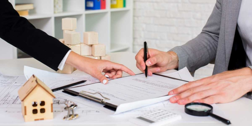 Registro de Incorporação Imobiliária: close nas mãos de duas pessoas assinando um papel.