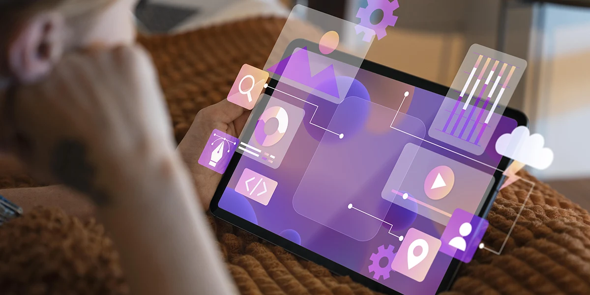 App para vendas: imagem de uma pessoa segurando um tablet. Da tela do tablet saem alguns ícones e gráficos.