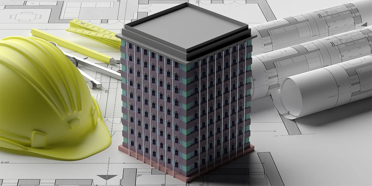3D na Construção: imagem de uma mesa com uma miniatura de um edifício, alguns papeis com plantas de imóveis e um capacete.