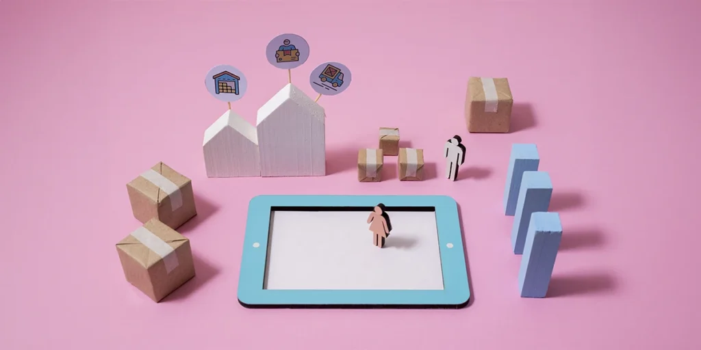 Automação com CRM imobiliário: a imagem apresenta algumas miniaturas como um tablet desenhado, blocos, pessoas e casas em madeira.