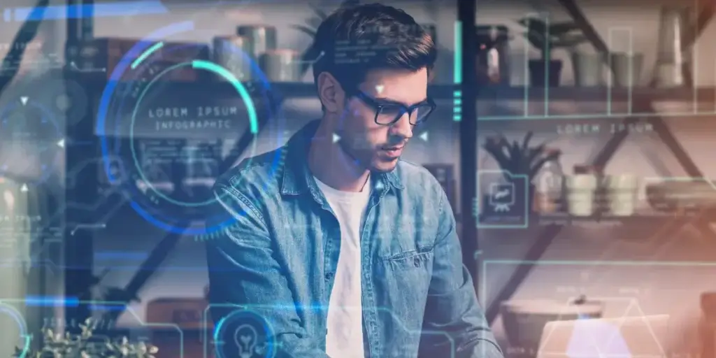 CRM com IA nativa CRM com IA nativa: imagem de um homem num escritório usando um notebook. Em destaque alguns gráficos e dashboards.