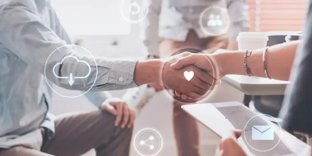 CRM de alta performance CRM de alta performance: imagem mostra o tronco de duas pessoas fazendo um gesto de cumprimento com as mãos. uma de frente para outra. Elas estão sentadas. Uma delas segura um tablet. Há ícones em 3D com imagem de coração, nuvem, carta, pessoa.