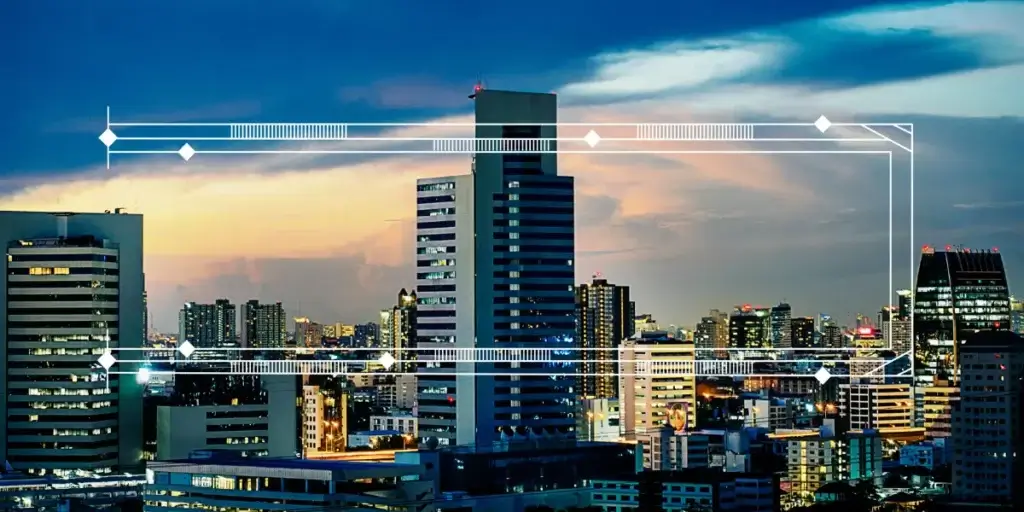 Captação de clientes imobiliários Captação de clientes imobiliários: imagem mostra uma cidade ao entardecer, com vários prédios com as luzes acesas.